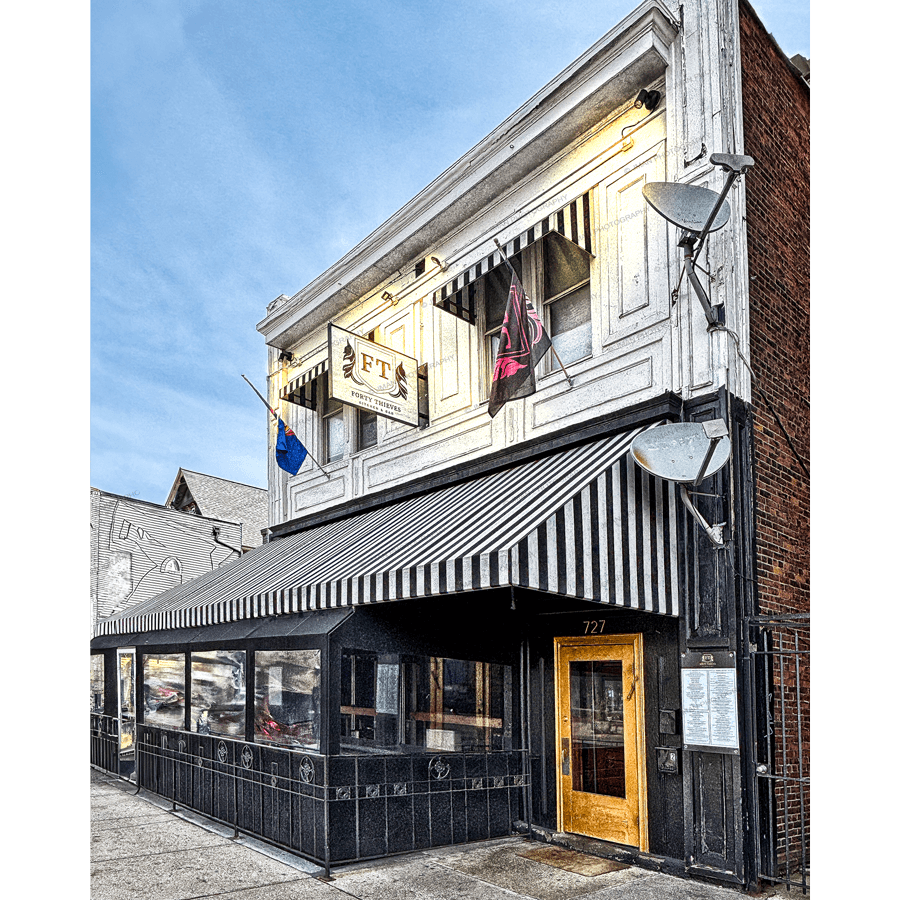 40 Thieves Cafe photo print featuring the iconic striped awning and rustic facade in Buffalo’s Elmwood District. Ideal for home or bar decor.