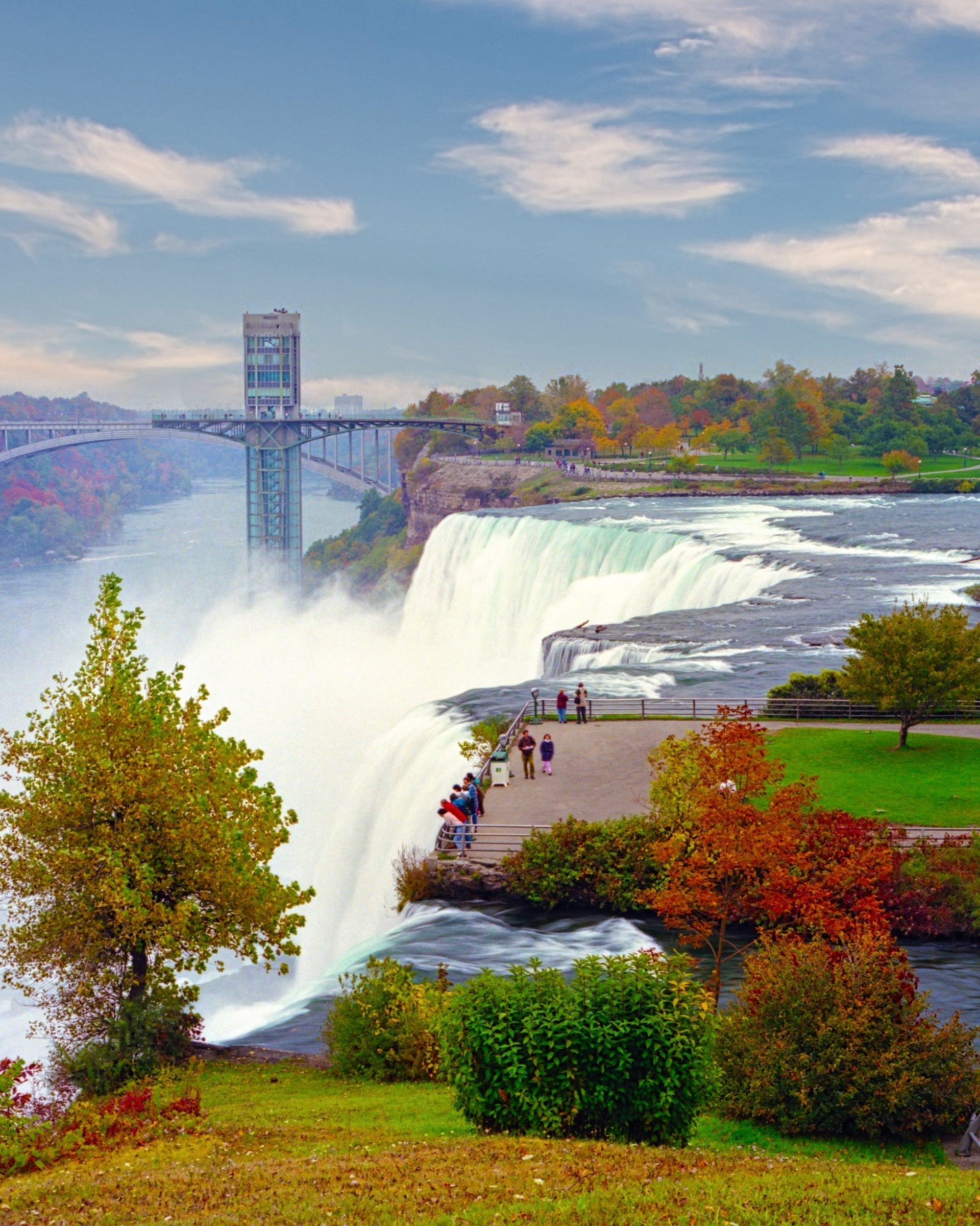 Colorful autumn view of Niagara Falls with observation tower and tourists, featured in vintage decor for Steampunk Table Lamp design.
