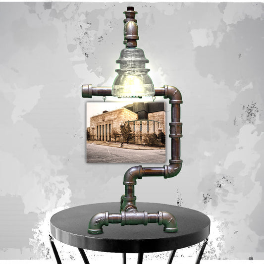 Buffalo Auditorium Lamp with steampunk pipe design and clear glass insulator light, featuring vintage Memorial Auditorium photo backdrop.