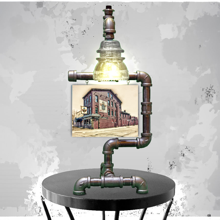 Industrial-style lamp stand displaying Anchor Bar Original Location - Buffalo Wings print, combining vintage lighting with iconic Buffalo landmark artwork.