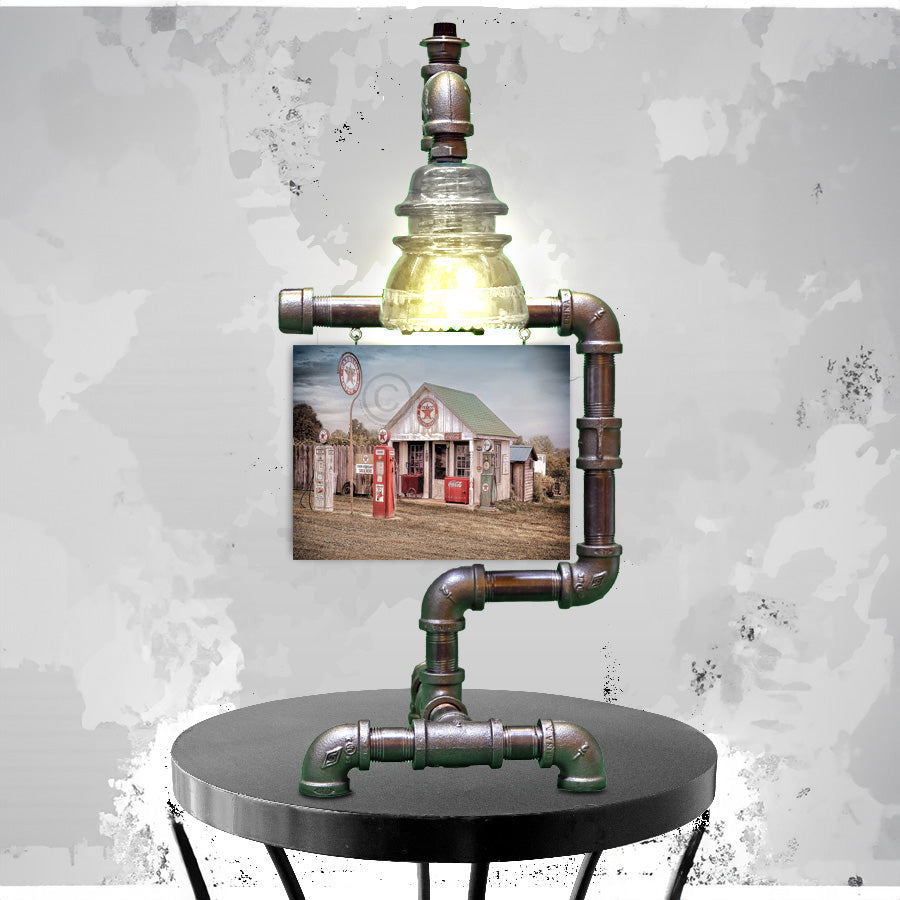 Texaco Station Print - Steampunk Table Lamp Insulator featuring a vintage-style lamp made from industrial pipes and a clear glass insulator, paired with a nostalgic Texaco gas station print. Ideal for rustic home decor or unique lighting accents.