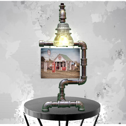 Texaco Station Print - Steampunk Table Lamp Insulator featuring a vintage-style lamp made from industrial pipes and a clear glass insulator, paired with a nostalgic Texaco gas station print. Ideal for rustic home decor or unique lighting accents.