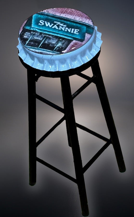Swannie Bottle Cap Bar Stool mini table with black wooden legs and a realistic bottle cap swivel seat. Ideal dollhouse accessory for bar playsets.