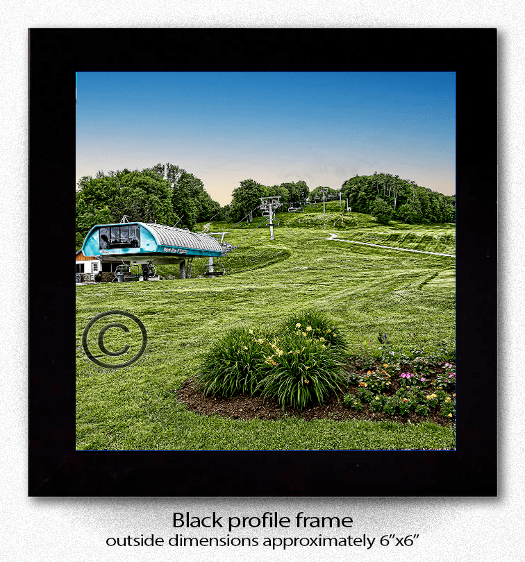 Framed ceramic coaster print of Holiday Valley Summer Mardi Grass Lift with black profile frame, perfect for home and garden decor.