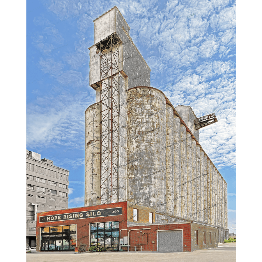 Hope Rising Wall Art - Jman Photography Print features a vivid photo of the historic Hope Rising Silo in Buffalo, NY under a bright blue sky.