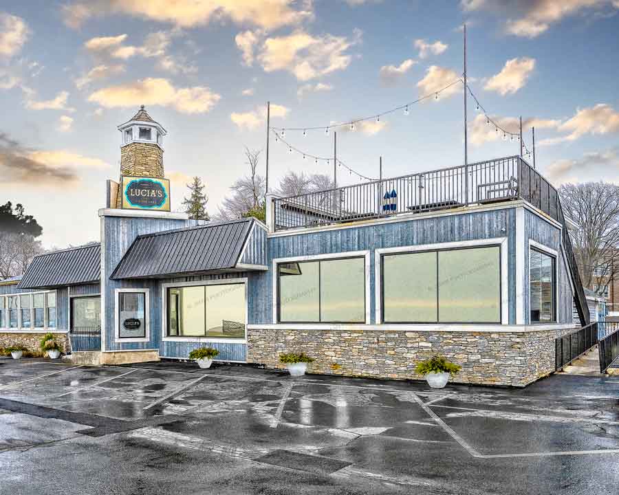 Lucia's Lake Photo Decor - Stunning Photographs | Jman Photos featuring a waterfront restaurant with lighthouse-style tower under a vibrant sky.