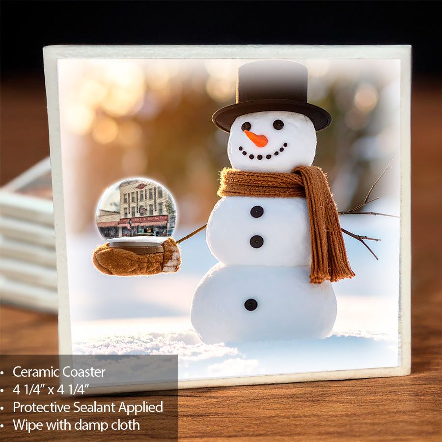 Ceramic Snowman Globe Coaster - Vidler's features a smiling snowman holding a globe with Vidler's storefront, ideal for winter barware decor.