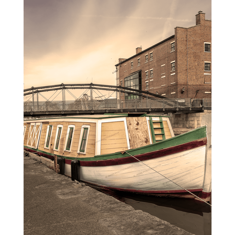 Erie Canal Boat Seneca Chief Print featuring a vintage canal boat docked at Canalside Buffalo with historic brick buildings and bridge at sunset.