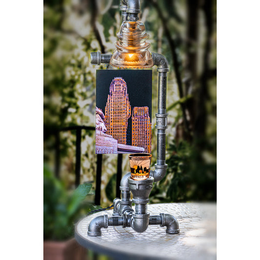 Steampunk lamp featuring Buffalo NY City Hall photo, clear glass insulator, and LED-lit shot glass. Industrial-style decor for home or office.