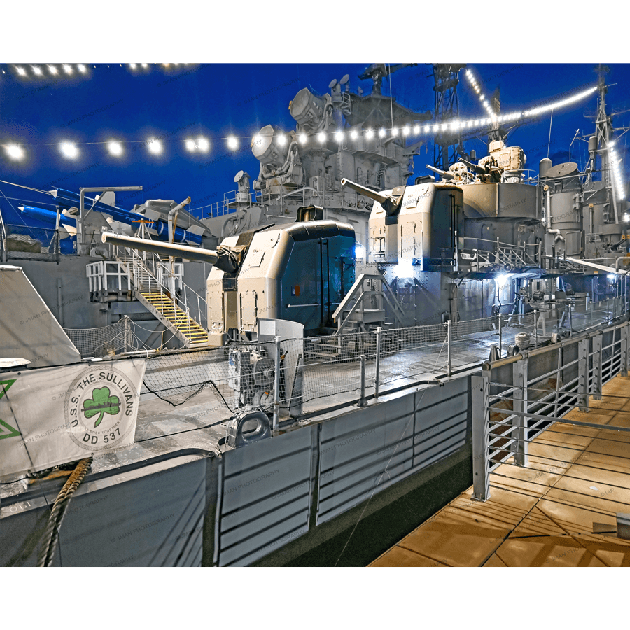 USS Sullivans Photo - USS Sullivans | Jman Photography print shows the historic naval ship docked at night with string lights, perfect for home or office decor.
