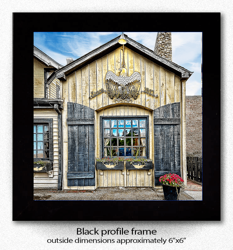 Framed Eagle House Coaster in black profile frame, approx. 6x6 inches, showcasing Buffalo architecture in a decorative ceramic design.