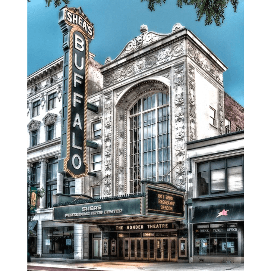 Shea's Buffalo Theatre with ornate facade and vertical neon sign, featured in colorful acrylic magnet for home or office decor.