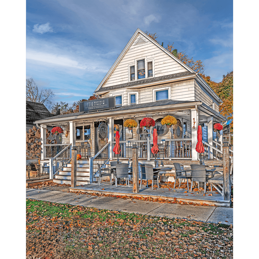 174 Buffalo St Photography Print featuring a charming white house restaurant with outdoor seating and fall decor in Hamburg, NY. A vibrant Buffalo landmark captured in autumn light.