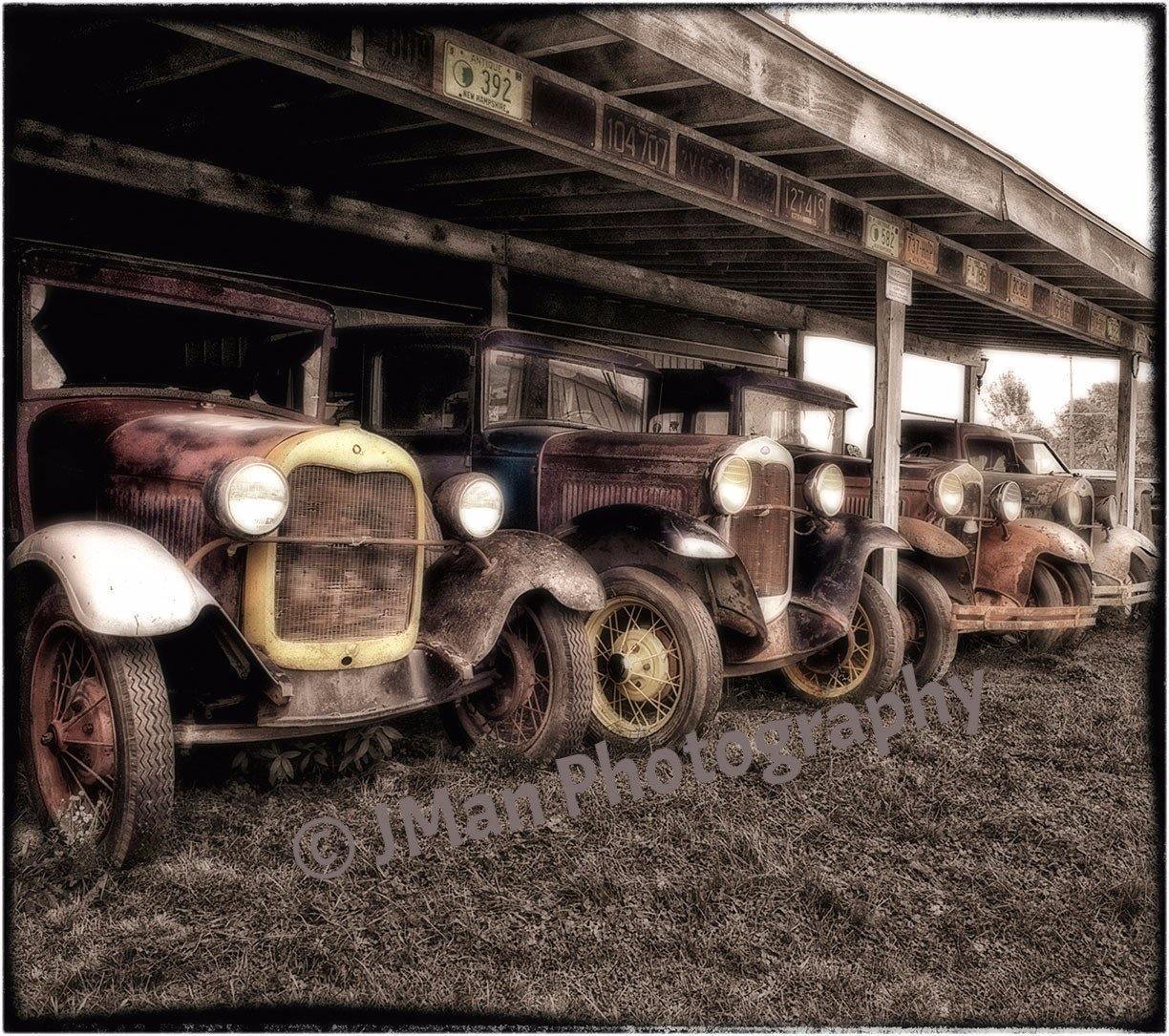 4 Fords Model T Photograph featuring vintage classic cars lined up under a rustic wooden shelter, ideal for automotive wall decor collectors.