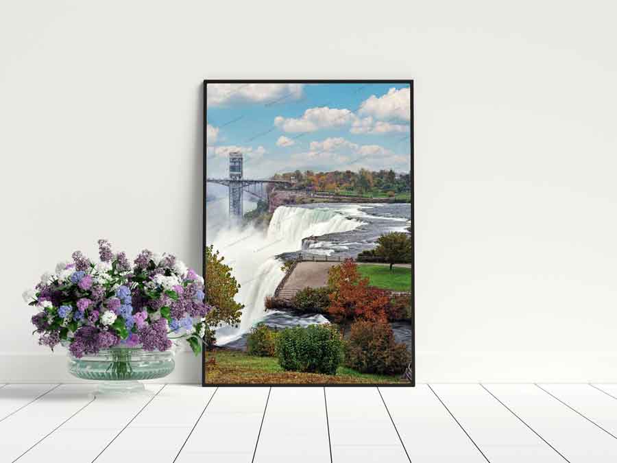 Framed American Falls in Fall - Niagara Photography print by Jman Artwork displayed in a modern home decor setting with floral arrangement.