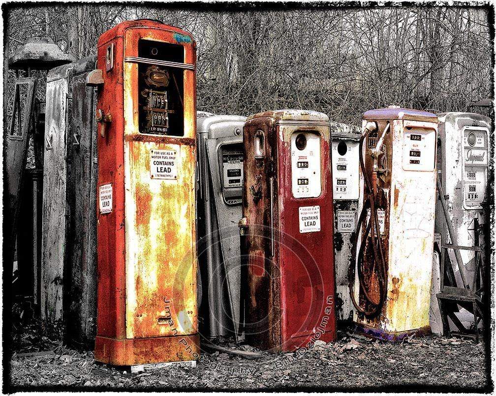 Old Vintage Gasoline Pumps Collection | Film Photography print featuring rusted petrol pumps in a wooded setting, perfect for automotive-themed wall decor.