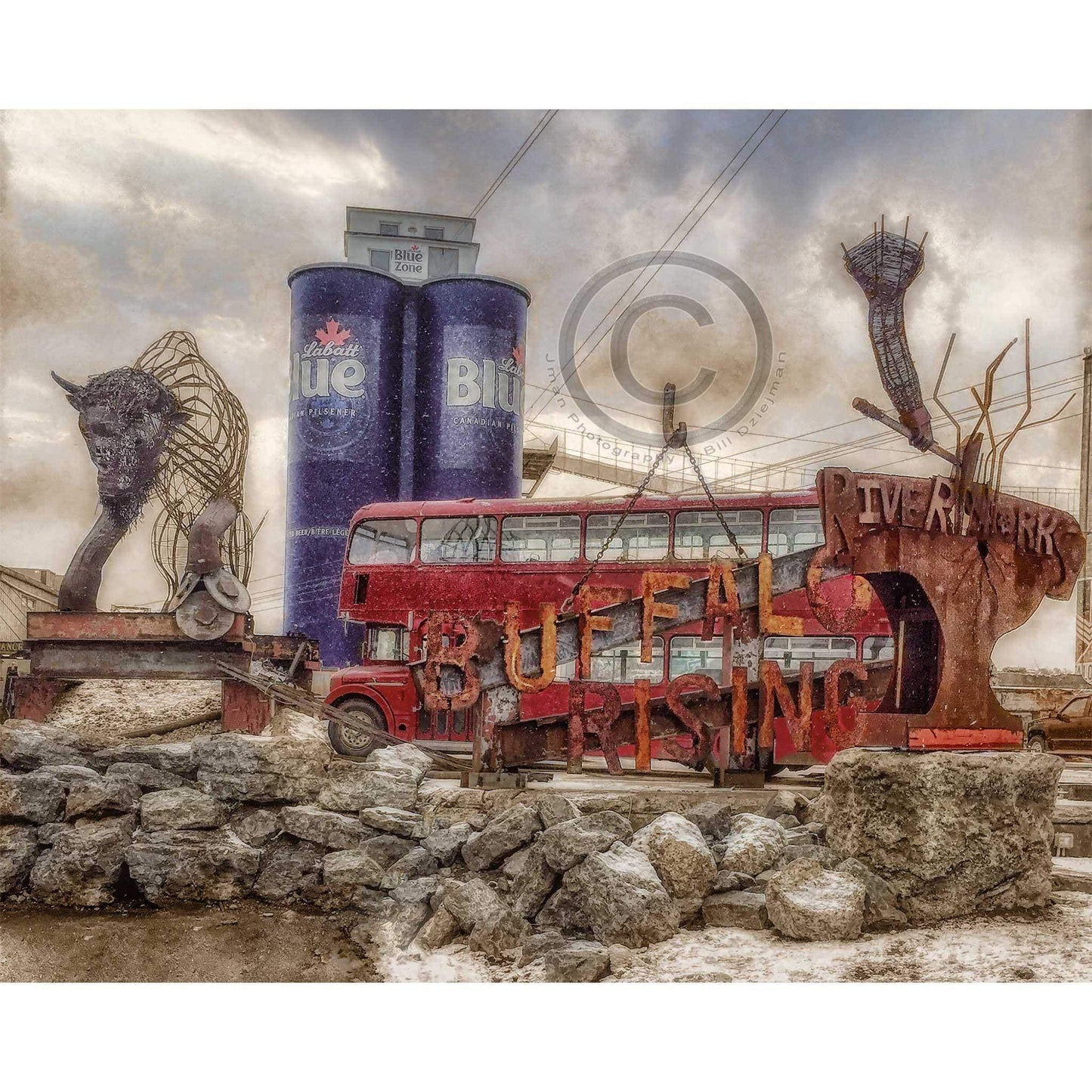 Riverworks Magnet - Buffalo features iconic Buffalo Rising sculpture, Labatt Blue silos, and red double-decker bus in vivid acrylic detail.