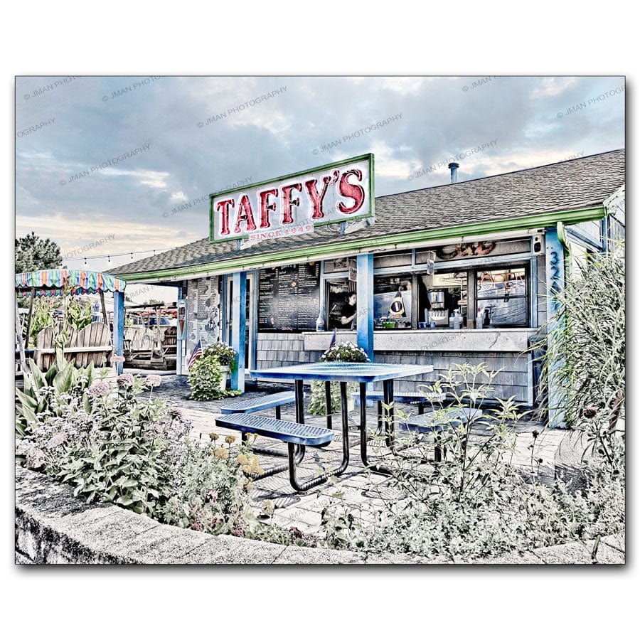 Taffy's Hot Dog Stand in Buffalo NY with outdoor seating, colorful signage, and lush garden decor. A nostalgic walk-up eatery since 1949.