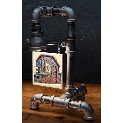 Custom pipe lamp with black industrial piping and a hanging tile image of a brick building, perfect for home decor or gift