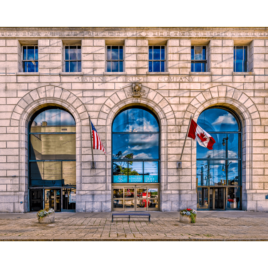 Admiral Room event space Buffalo in Marin Building with American and Canadian flags, historic architecture, and arched windows reflecting cityscape.