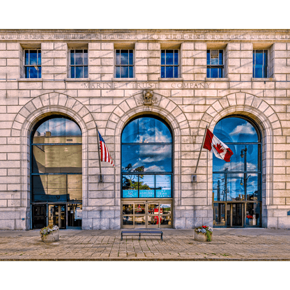 Admiral Room event space Buffalo in Marin Building with American and Canadian flags, historic architecture, and arched windows reflecting cityscape.