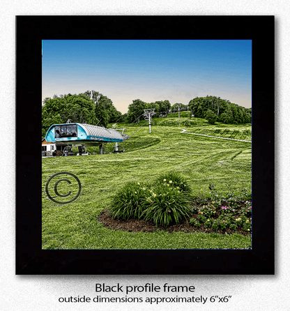 Framed ceramic coaster print of Holiday Valley Summer Mardi Grass Lift with black profile frame, perfect for home and garden decor.