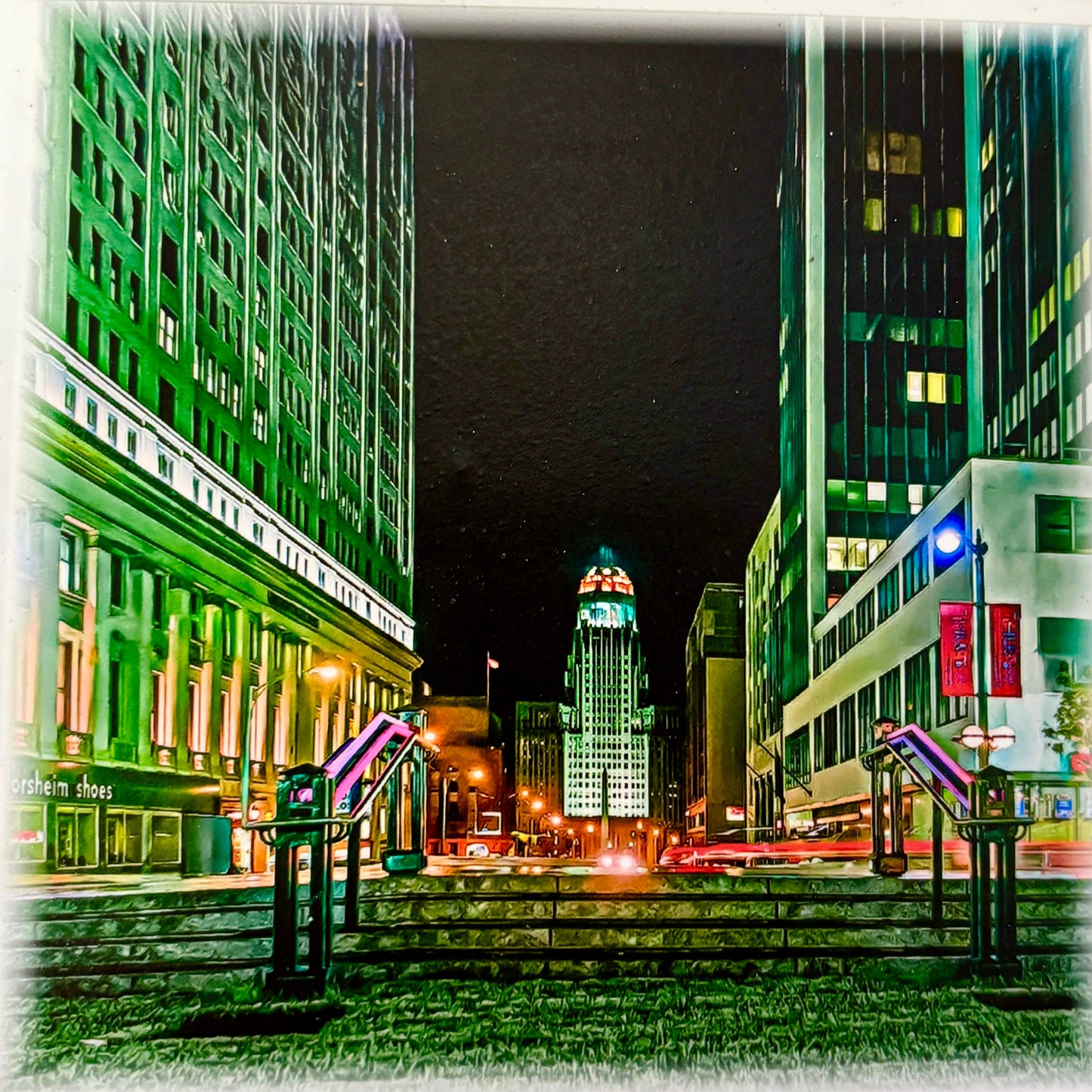 Buffalo Lafayete Square City street at night with tall buildings and city hall illuminated tower.
