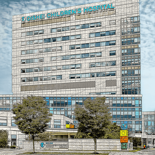 Oishei Childrens Coaster featuring a detailed ceramic print of Oishei Children's Hospital building. Durable with cork backing for furniture protection.