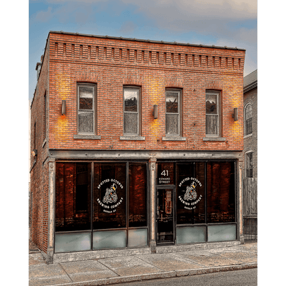 Spotted Octopus Brewing Photography - Taproom & Beer Visuals featuring the brick exterior of Spotted Octopus Brewing Co. in Buffalo, NY with logo windows and warm lighting. Ideal for home decor with Buffalo-WNY photo nostalgia.