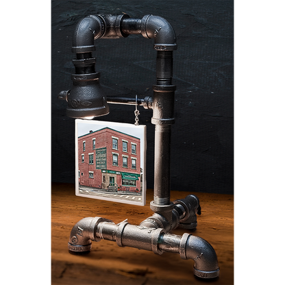 Custom pipe lamp with black industrial piping and a 4x4 tile image of a brick building with storefront, perfect for home decor