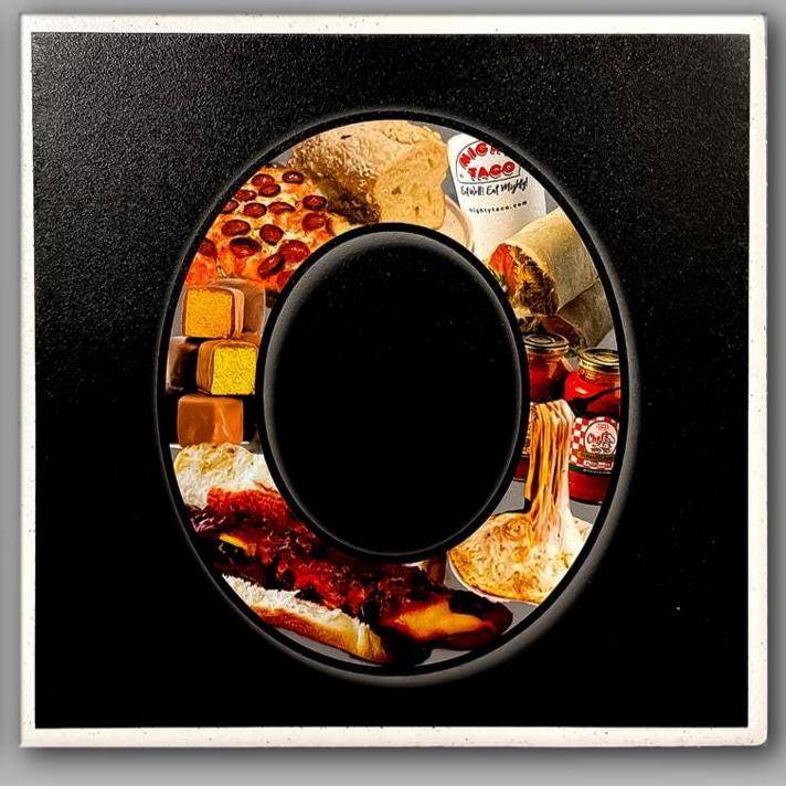 Letter O coaster from Bflo Flavor Coasters set, filled with Buffalo treats like sponge candy, pizza logs, and Ted’s hot dogs on a ceramic tile.